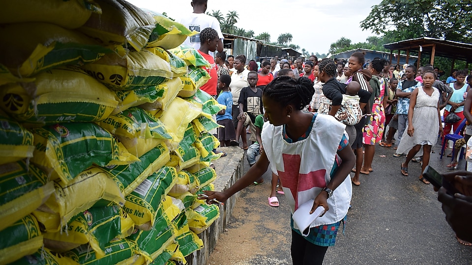 A Red-Cross officer takes record of SPDC JV relief materials for  flood victims at Patani IDP Camp in Delta State.