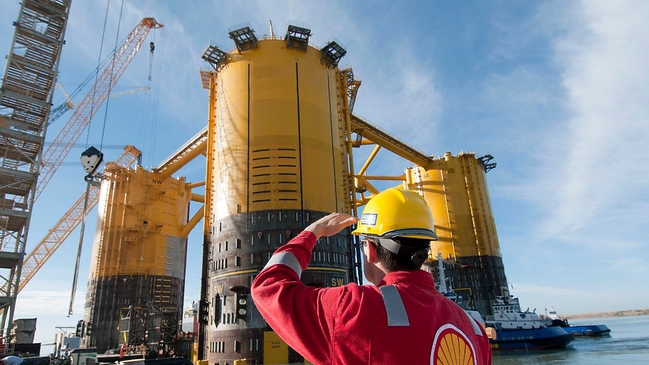Engineer looking up at platform under construction