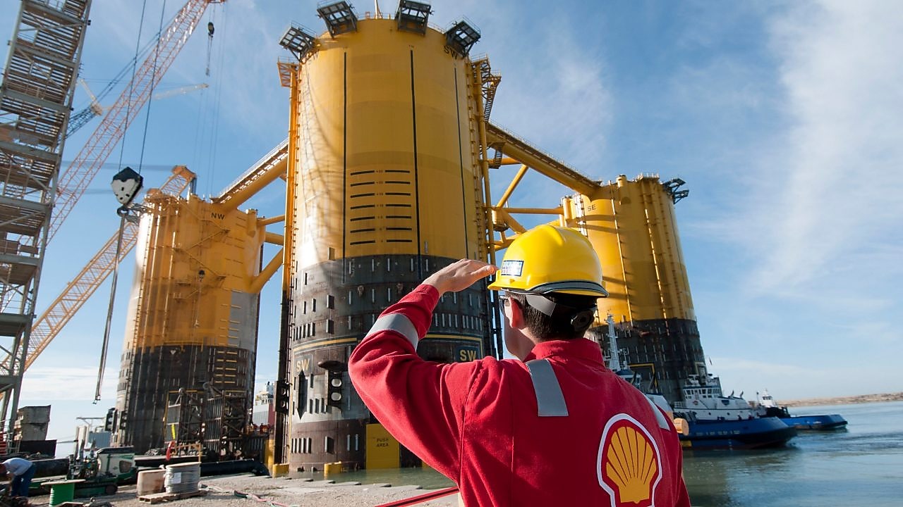Engineer looking up at platform under construction