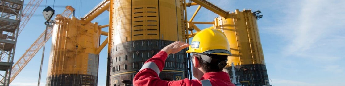 Engineer looking up at platform under construction