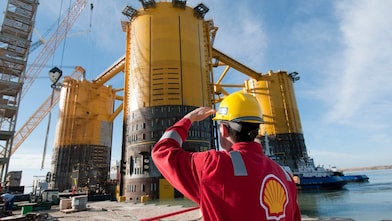 Engineer looking up at platform under construction
