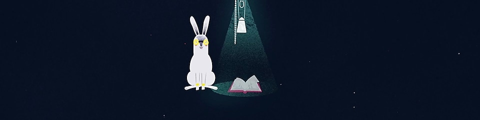 An illustrated rabbit sits beside a story book illuminated by a GravityLight