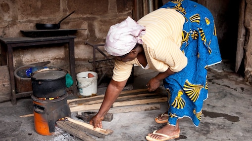 Lady cooking on a cookstove in Nigeria